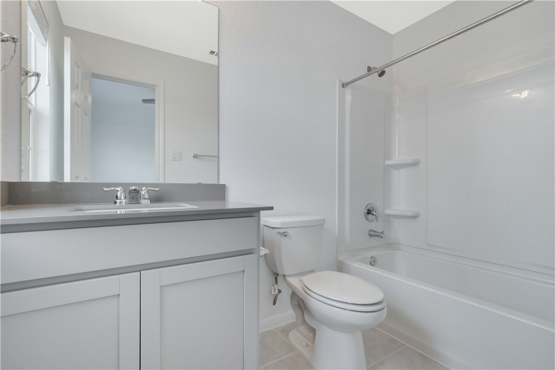 17629 Shafer Drive Pflugerville, TX 78660 - Photo 21 of 35 a bathroom with a sink a toilet and a bathtub