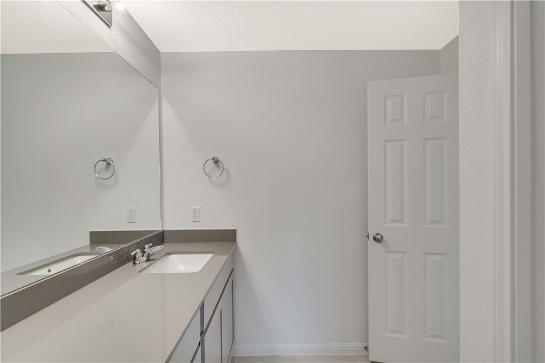 17629 Shafer Drive Pflugerville, TX 78660 - Photo 27 of 35 a bathroom with a sink and a mirror
