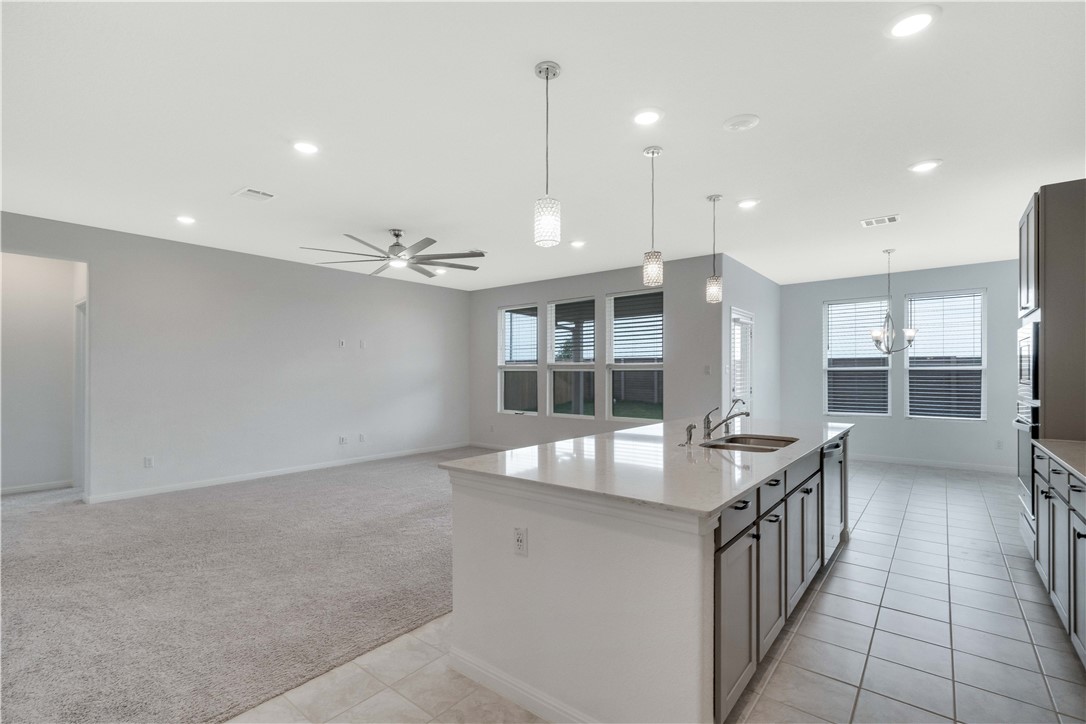 17629 Shafer Drive Pflugerville, TX 78660 - Photo 9 of 35 a kitchen with counter top space and a sink