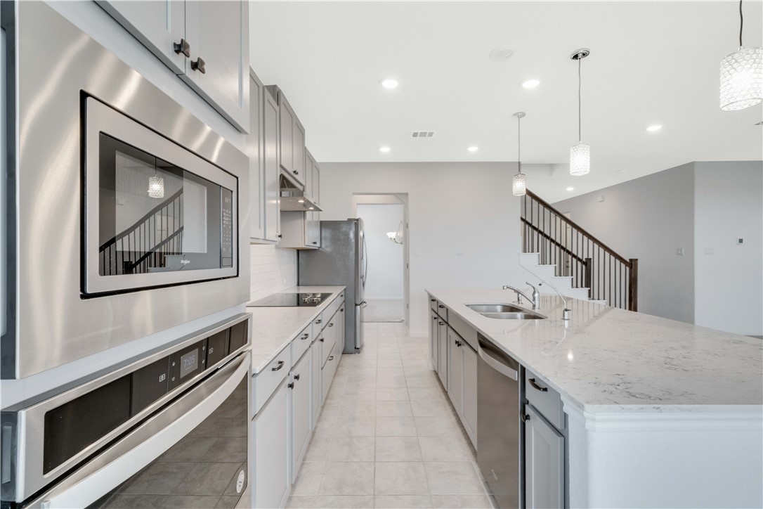 17629 Shafer Drive Pflugerville, TX 78660 - Photo 10 of 35 a kitchen with sink stove and cabinets