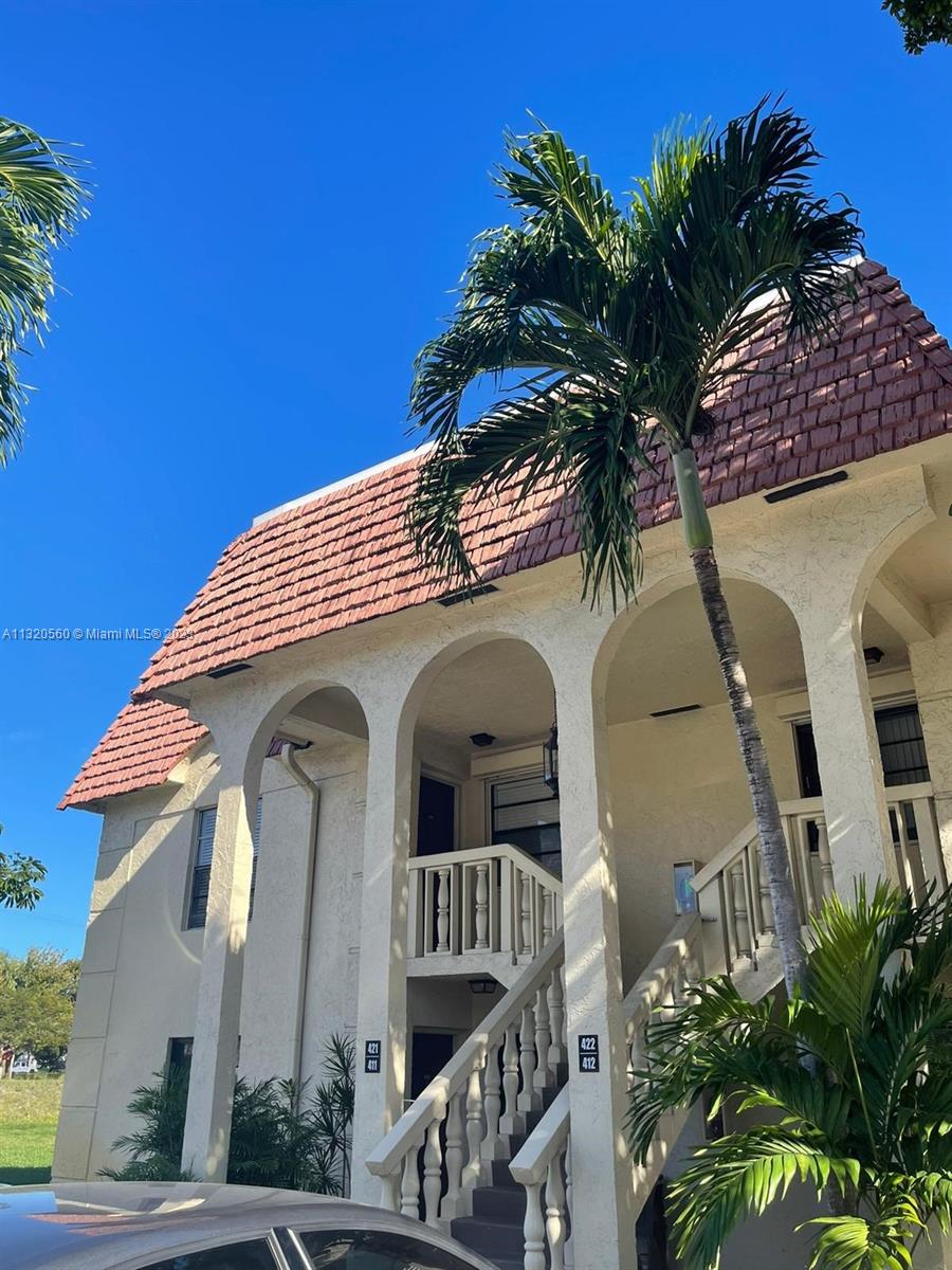 a front view of a house with plants