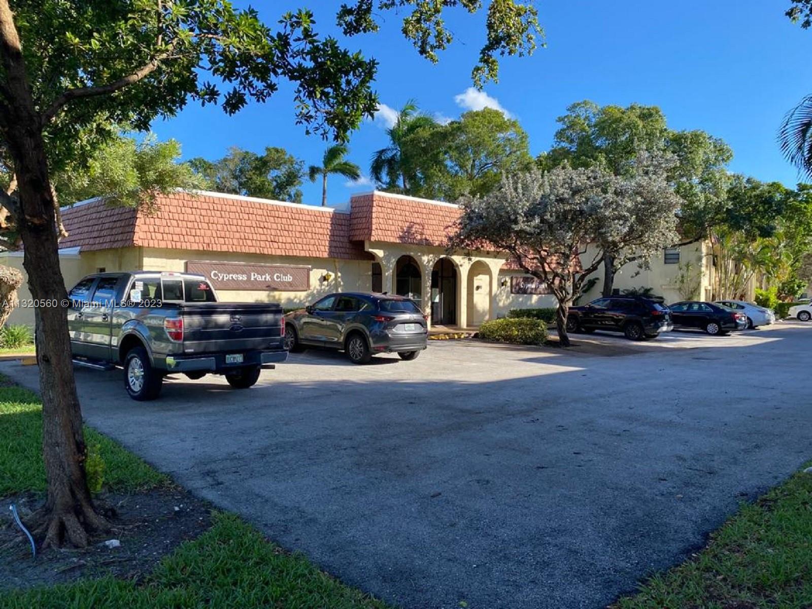 134 South Cypress Road, Unit 421 Pompano Beach, FL 33060 - Photo 12 of 12 a view of a car parked in front of a house