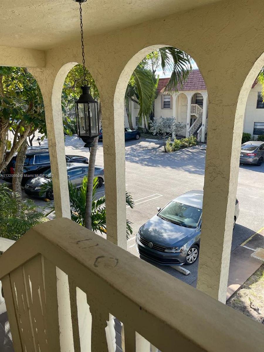 134 South Cypress Road, Unit 421 Pompano Beach, FL 33060 - Photo 2 of 12 a front view of a house with garden