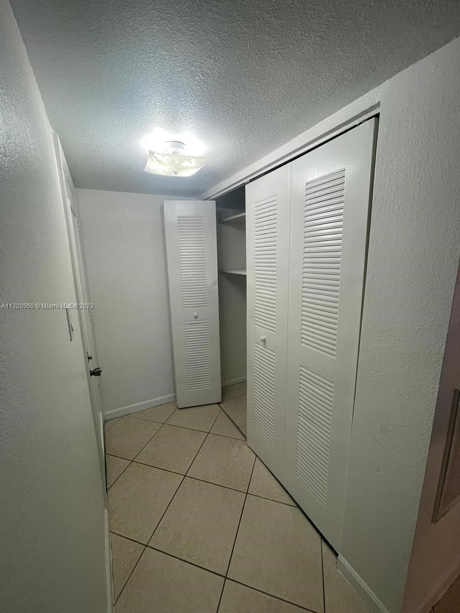 134 South Cypress Road, Unit 421 Pompano Beach, FL 33060 - Photo 3 of 12 a bathroom with a shower and a glass door