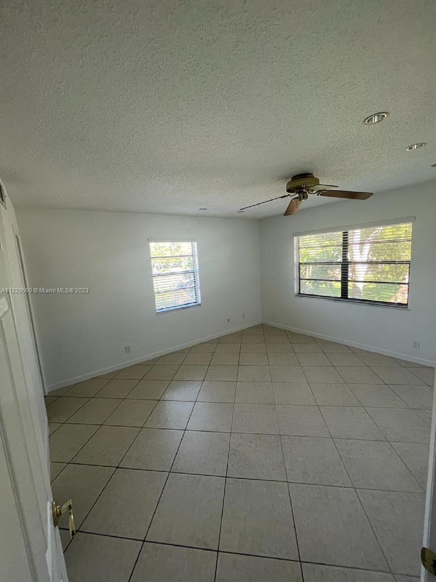 134 South Cypress Road, Unit 421 Pompano Beach, FL 33060 - Photo 6 of 12 a view of an empty room with a window
