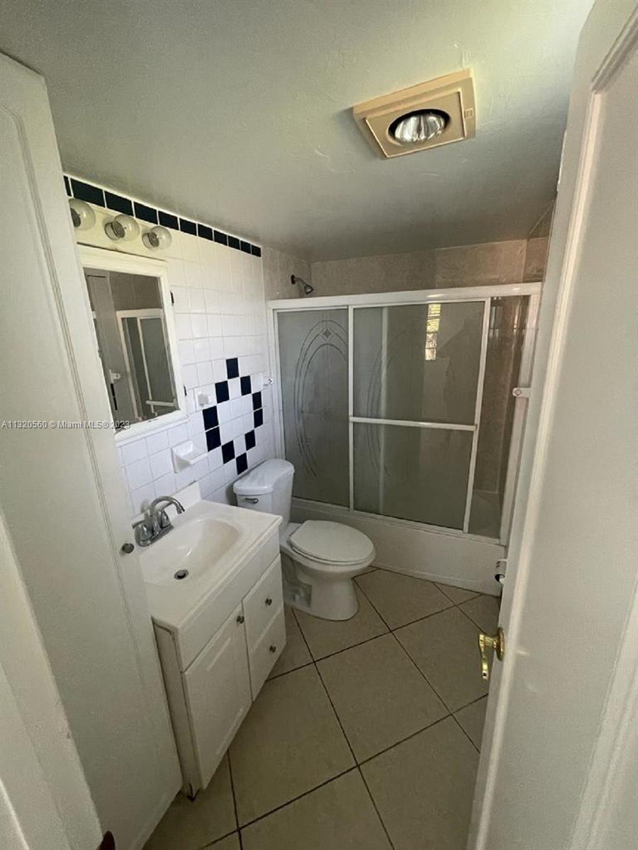 134 South Cypress Road, Unit 421 Pompano Beach, FL 33060 - Photo 8 of 12 a bathroom with a sink mirror and toilet