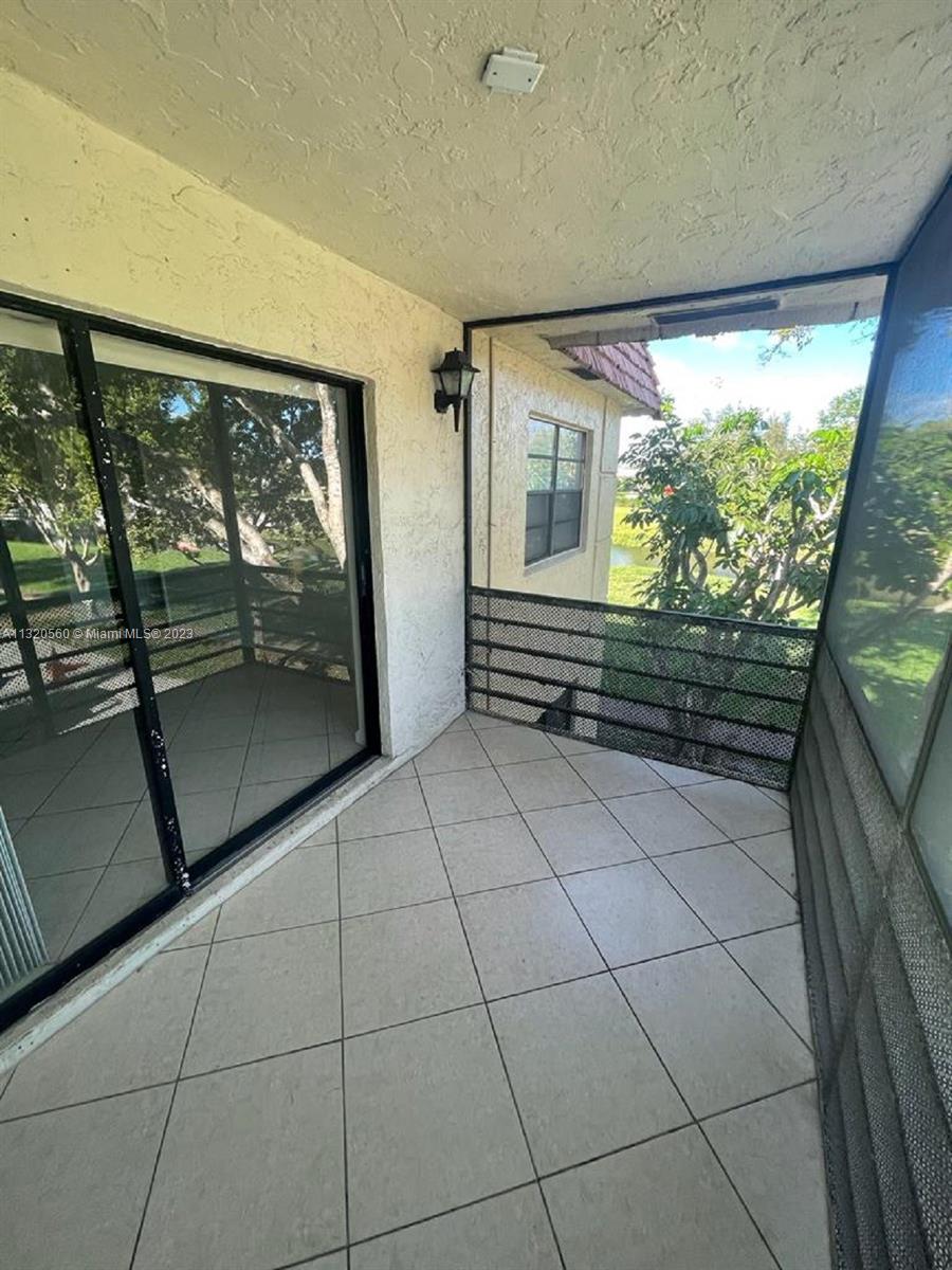 134 South Cypress Road, Unit 421 Pompano Beach, FL 33060 - Photo 9 of 12 a view of outdoor space with wooden floor