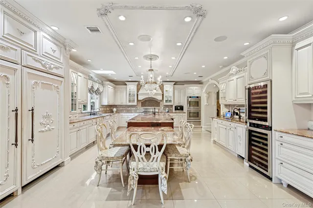 a kitchen with stainless steel appliances kitchen island granite countertop a refrigerator and cabinets