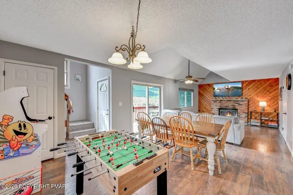 a view of a dining room with furniture a chandelier and wooden floor