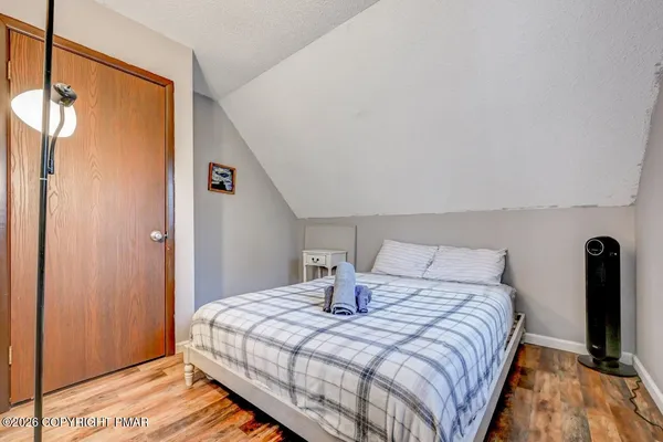 a bedroom with a bed and a mirror