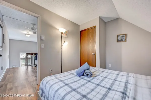 a bedroom with a bed and wooden floor