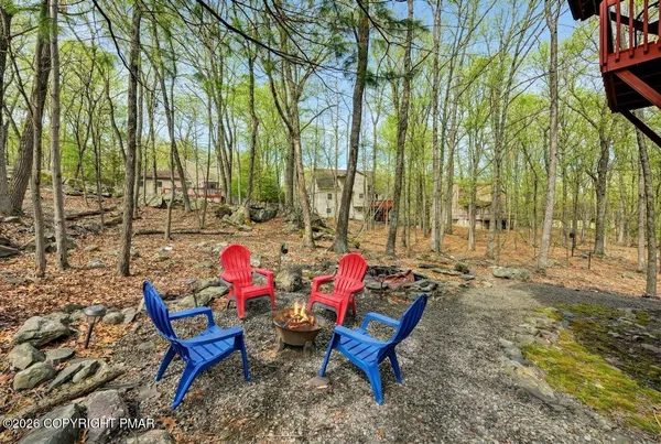 an outdoor sitting area with couch and chairs