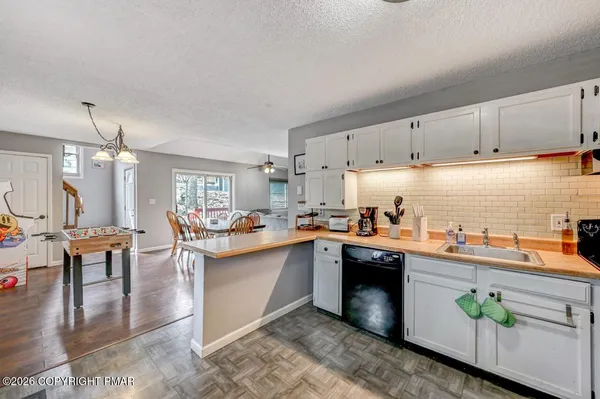 a kitchen with stainless steel appliances granite countertop a lot of counter space and wooden floors