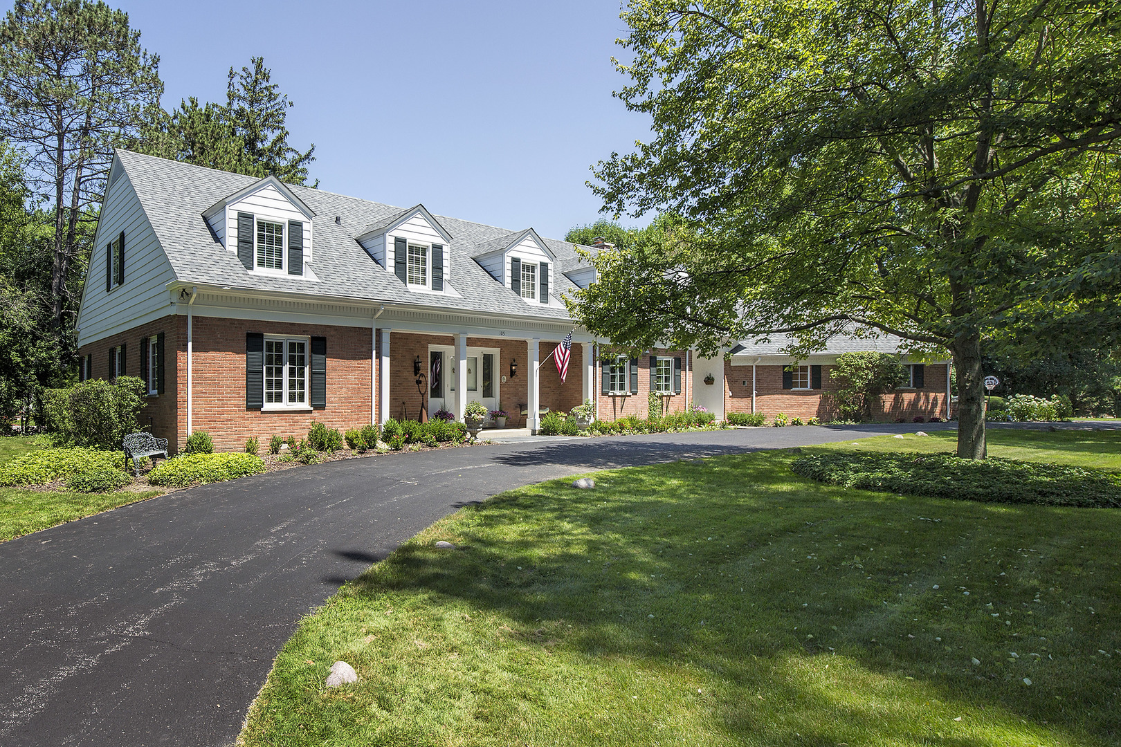 105 Woodley Road Winnetka, IL 60093 - Photo 1 of 23 a front view of a house with a garden