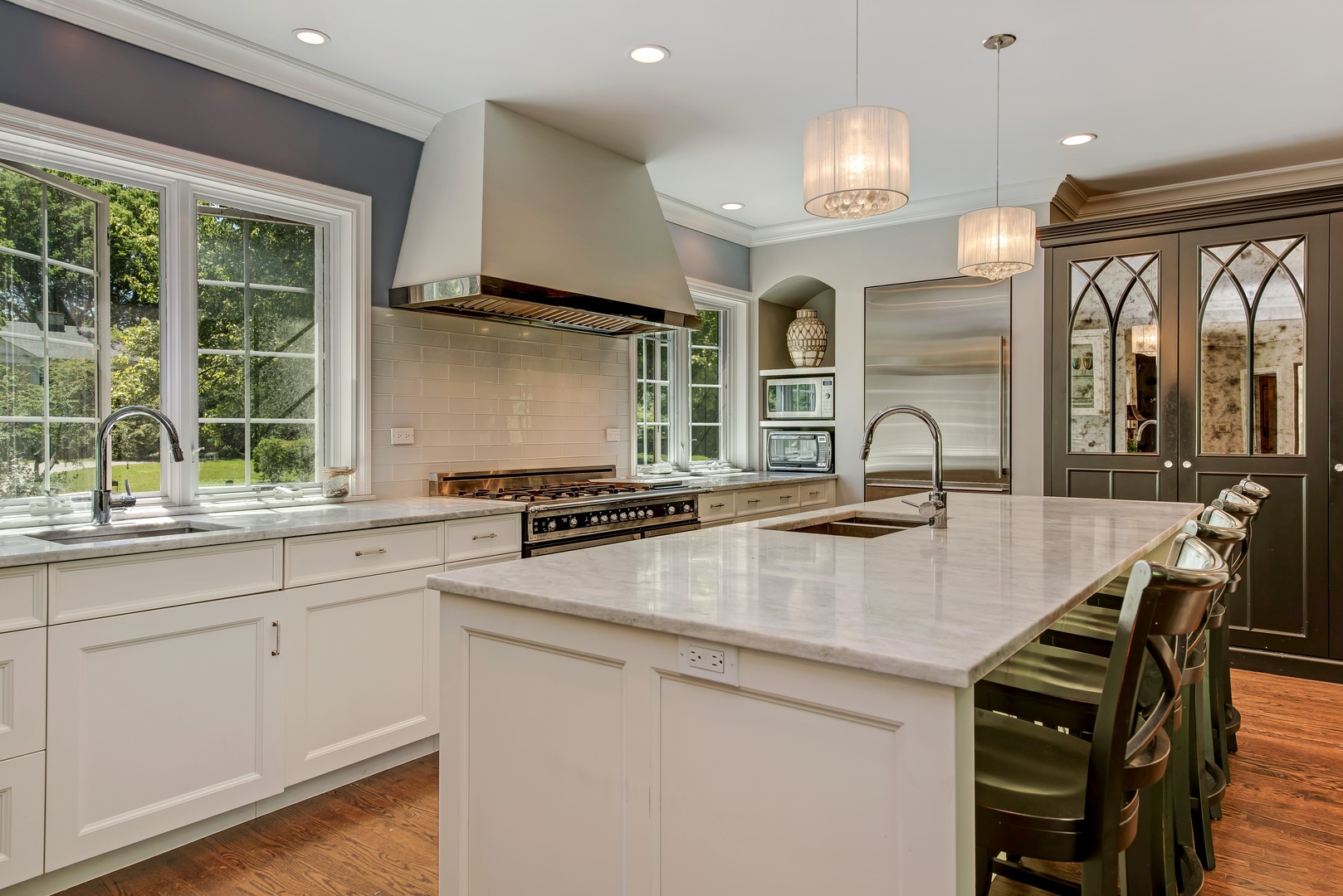 105 Woodley Road Winnetka, IL 60093 - Photo 6 of 23 a kitchen with stainless steel appliances granite countertop a sink a stove and a microwave