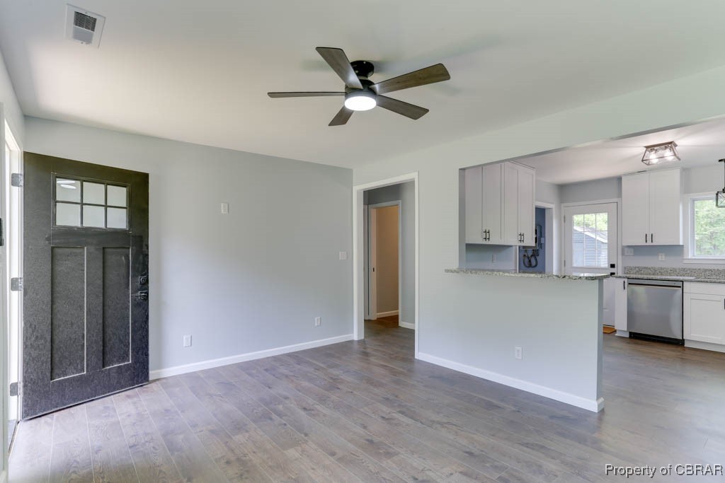 917 Chapel Neck Road North, VA 23128 - Photo 5 of 29 Unfurnished living room with a ceiling fan, wood finished floors, and baseboards