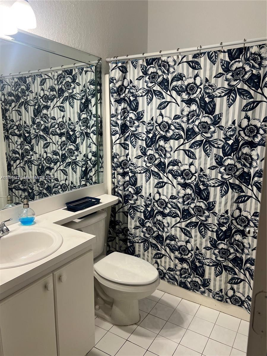 7667 Northwest 182nd Lane, Unit 805 Hialeah, FL 33015 - Photo 12 of 14 a bathroom with a sink toilet and shower