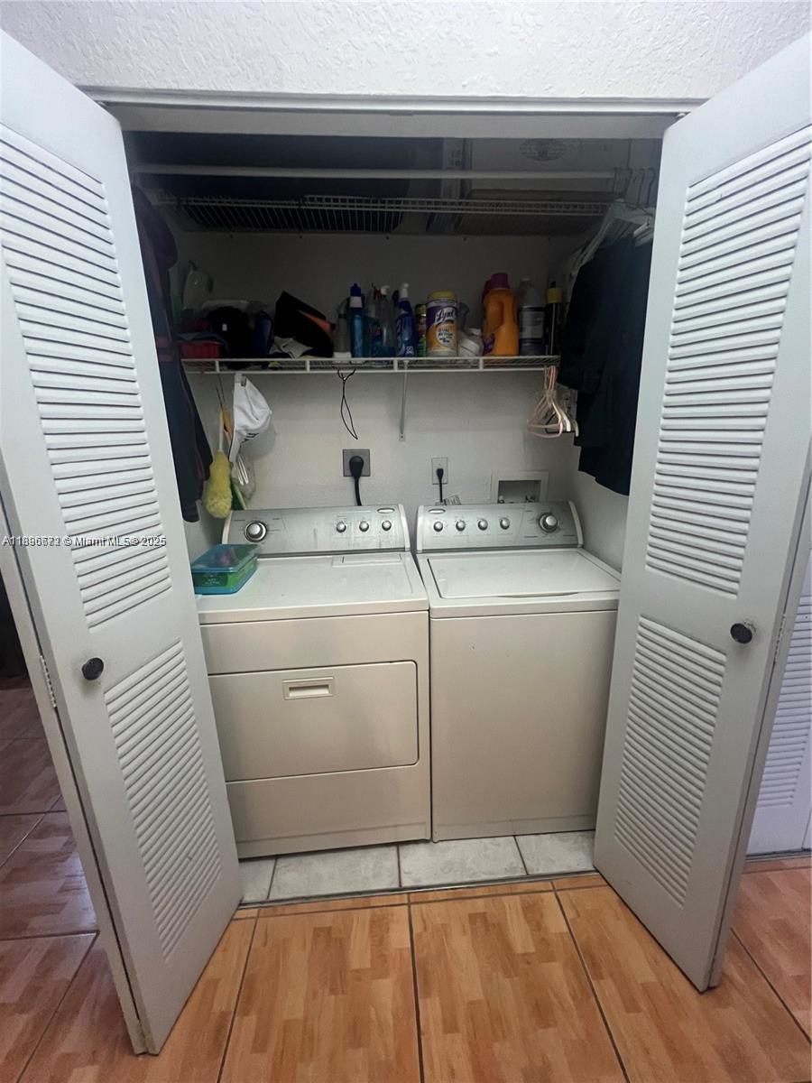 7667 Northwest 182nd Lane, Unit 805 Hialeah, FL 33015 - Photo 13 of 14 a utility room with dryer and washer