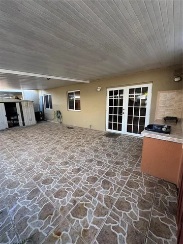 a large bedroom with a bed and cabinets