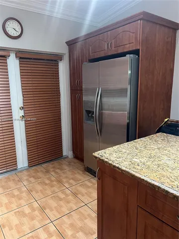 a kitchen with a refrigerator and a sink