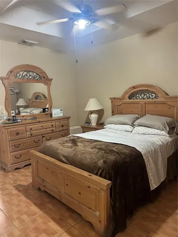 a bedroom with a bed and lamp