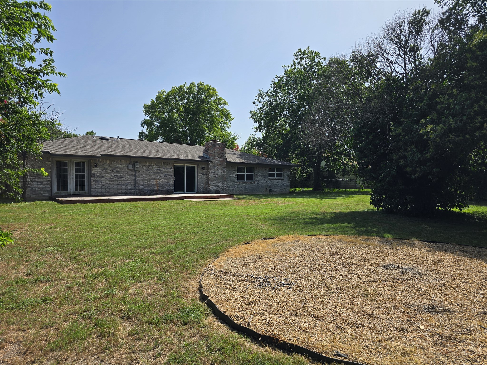 205 East Cherokee Drive Harker Heights, TX 76548 - Photo 21 of 23 A spacious backyard with mature trees offers a private oasis, perfect for outdoor living and relaxation.