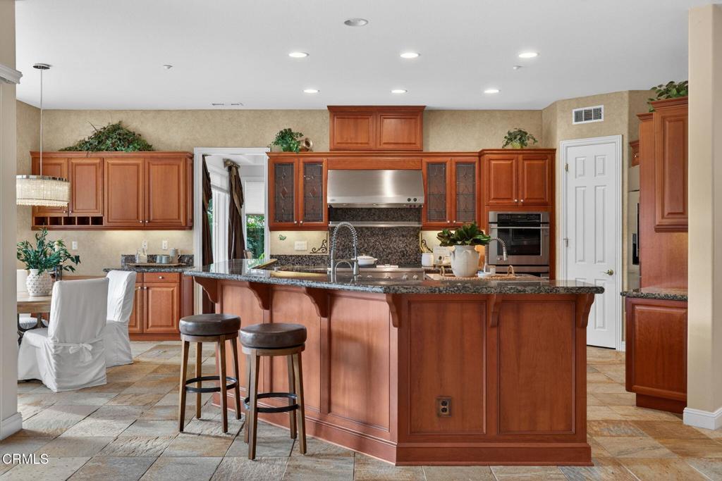 5352 Plata Rosa Court Camarillo, CA 93012 - Photo 24 of 75 a kitchen with stainless steel appliances granite countertop a refrigerator a sink a stove a dining table and chairs