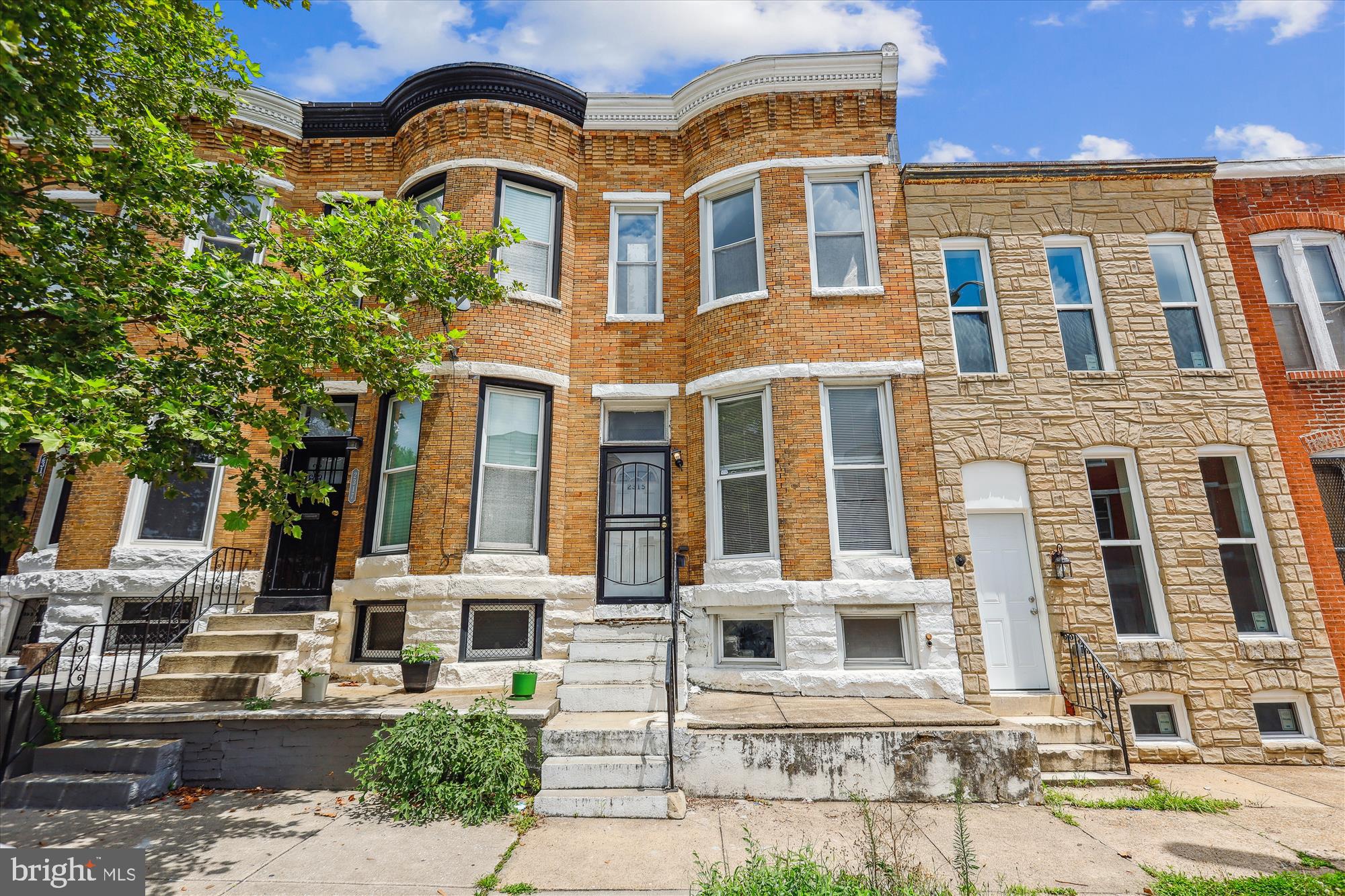 2315 McCulloh Street Baltimore, MD 21217 - Photo 2 of 40 a front view of a residential apartment building with a yard