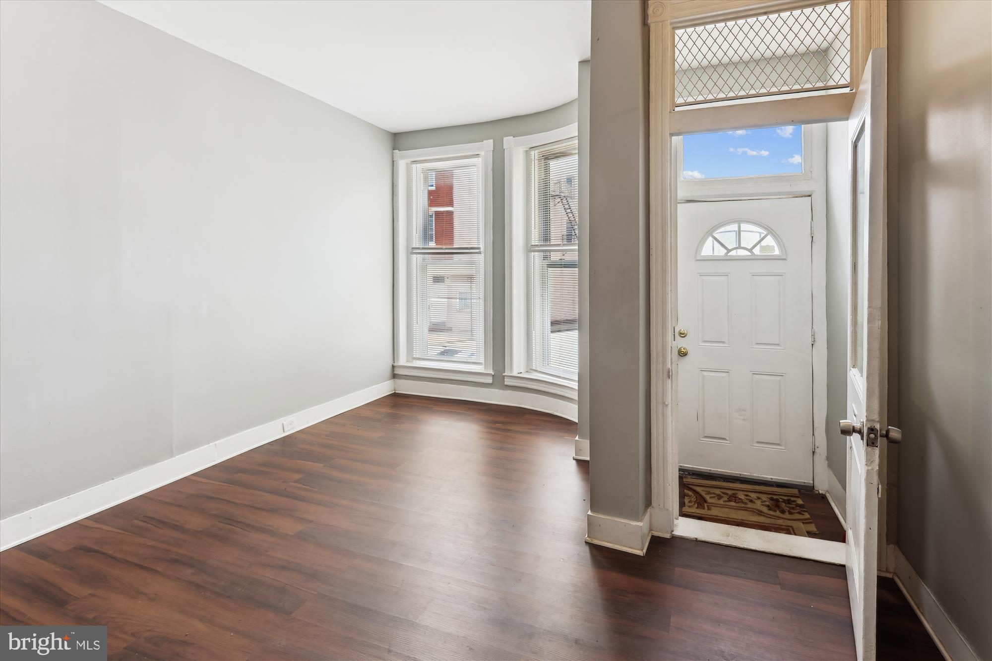 2315 McCulloh Street Baltimore, MD 21217 - Photo 3 of 40 an empty room with wooden floor wooden floor and windows