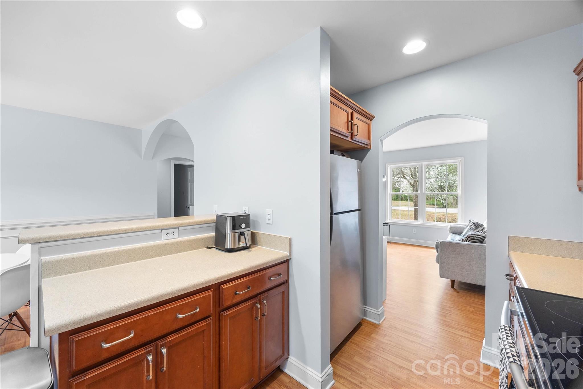 219 Nottingham Street York, SC 29745 - Photo 12 of 38 a kitchen with stainless steel appliances granite countertop a sink dishwasher a stove and white cabinets with wooden floor