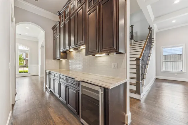 a view of hallway with stairs and wooden floor
