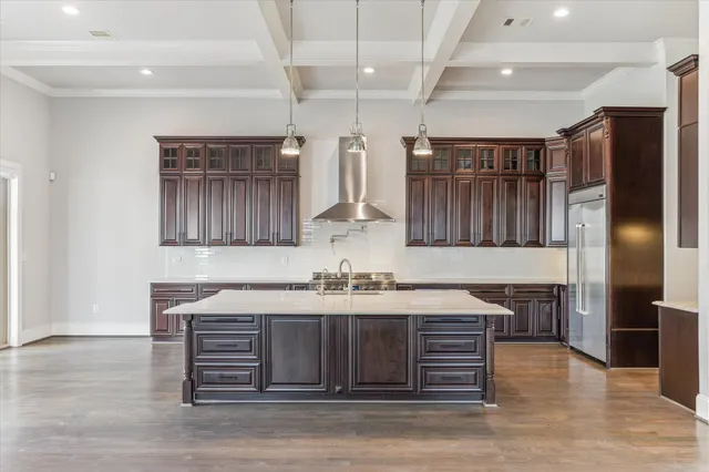 a kitchen with kitchen island a counter top space cabinets and stainless steel appliances