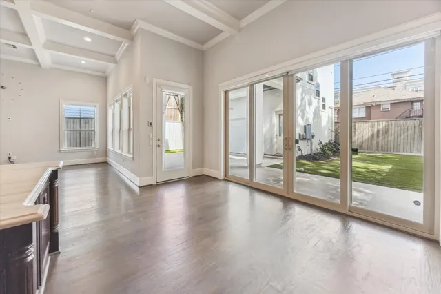 a view of an entryway with wooden floor