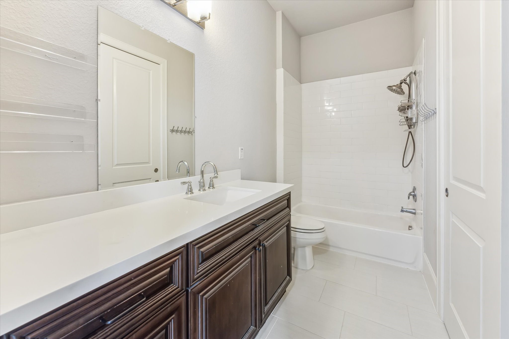 1721 Colquitt Street Houston, TX 77098 - Photo 15 of 30 a bathroom with a granite countertop sink a toilet and shower