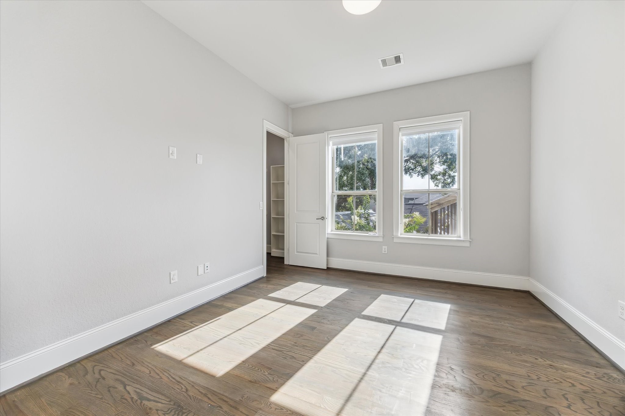 1721 Colquitt Street Houston, TX 77098 - Photo 17 of 30 an empty room with wooden floor and windows