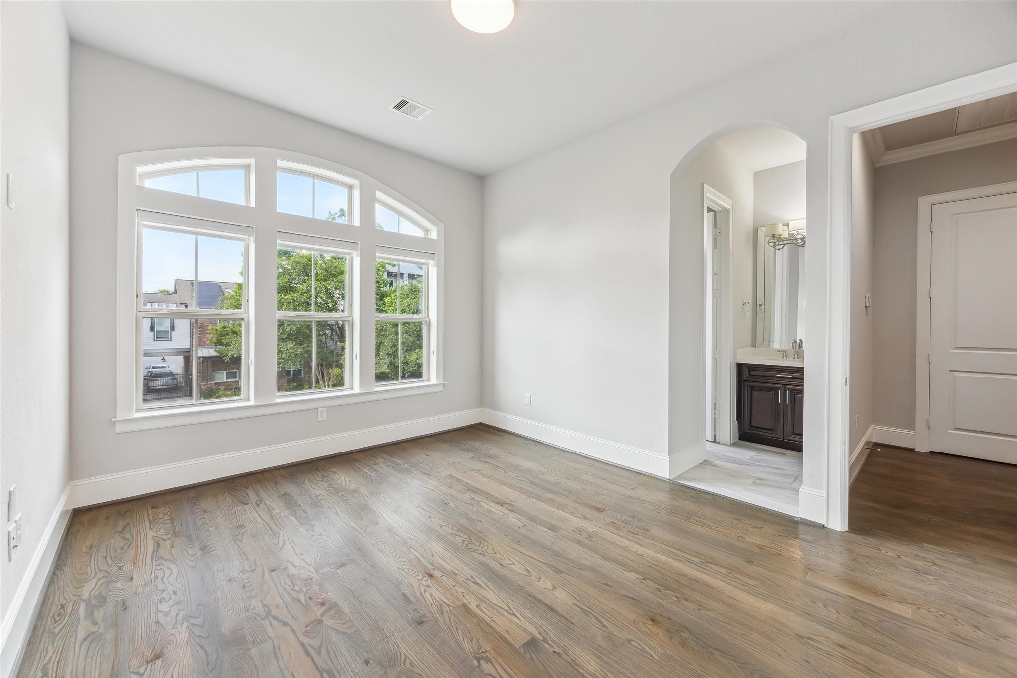 1721 Colquitt Street Houston, TX 77098 - Photo 18 of 30 an empty room with wooden floor cabinet and windows