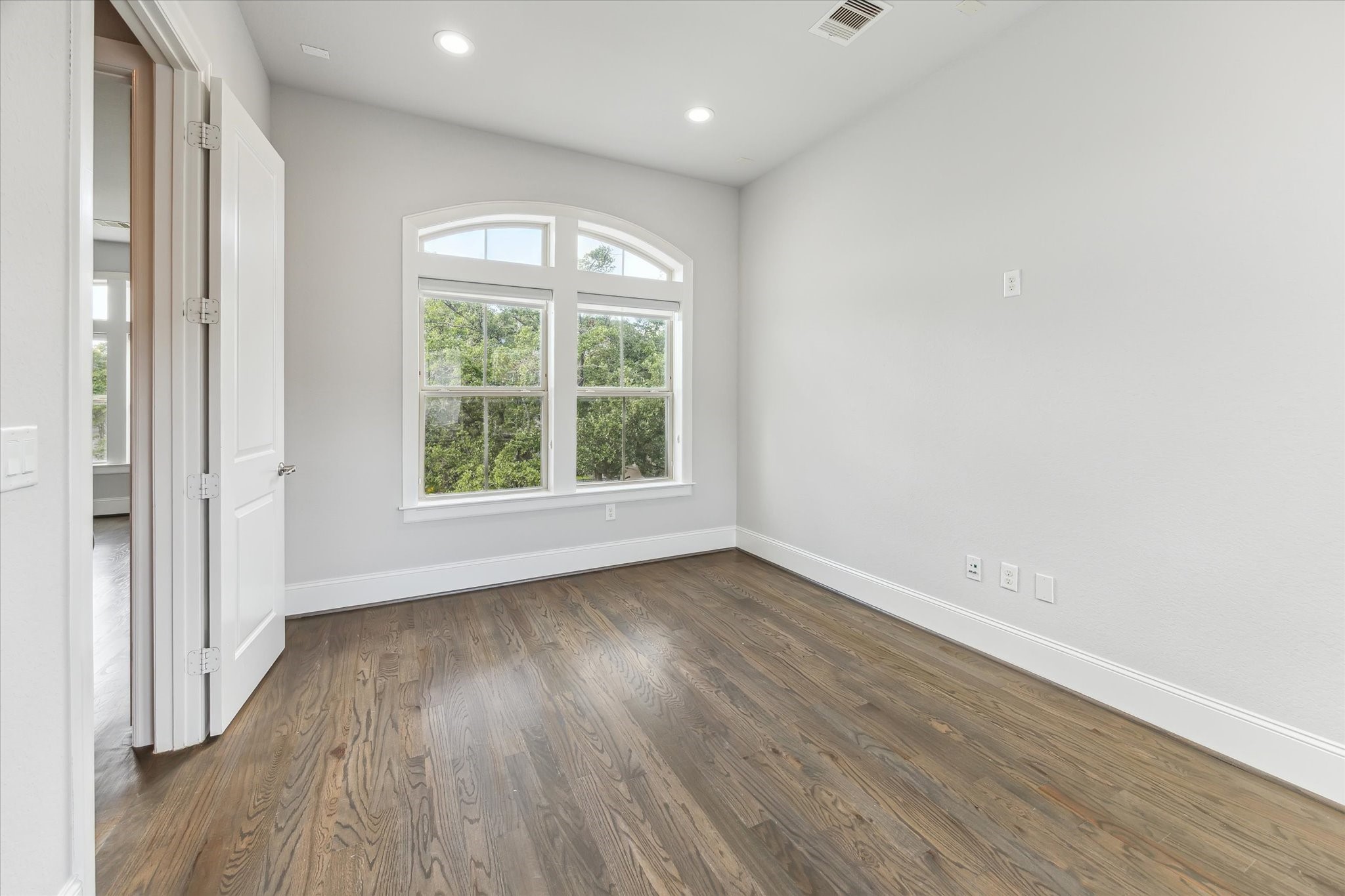 1721 Colquitt Street Houston, TX 77098 - Photo 21 of 30 an empty room with wooden floor and windows