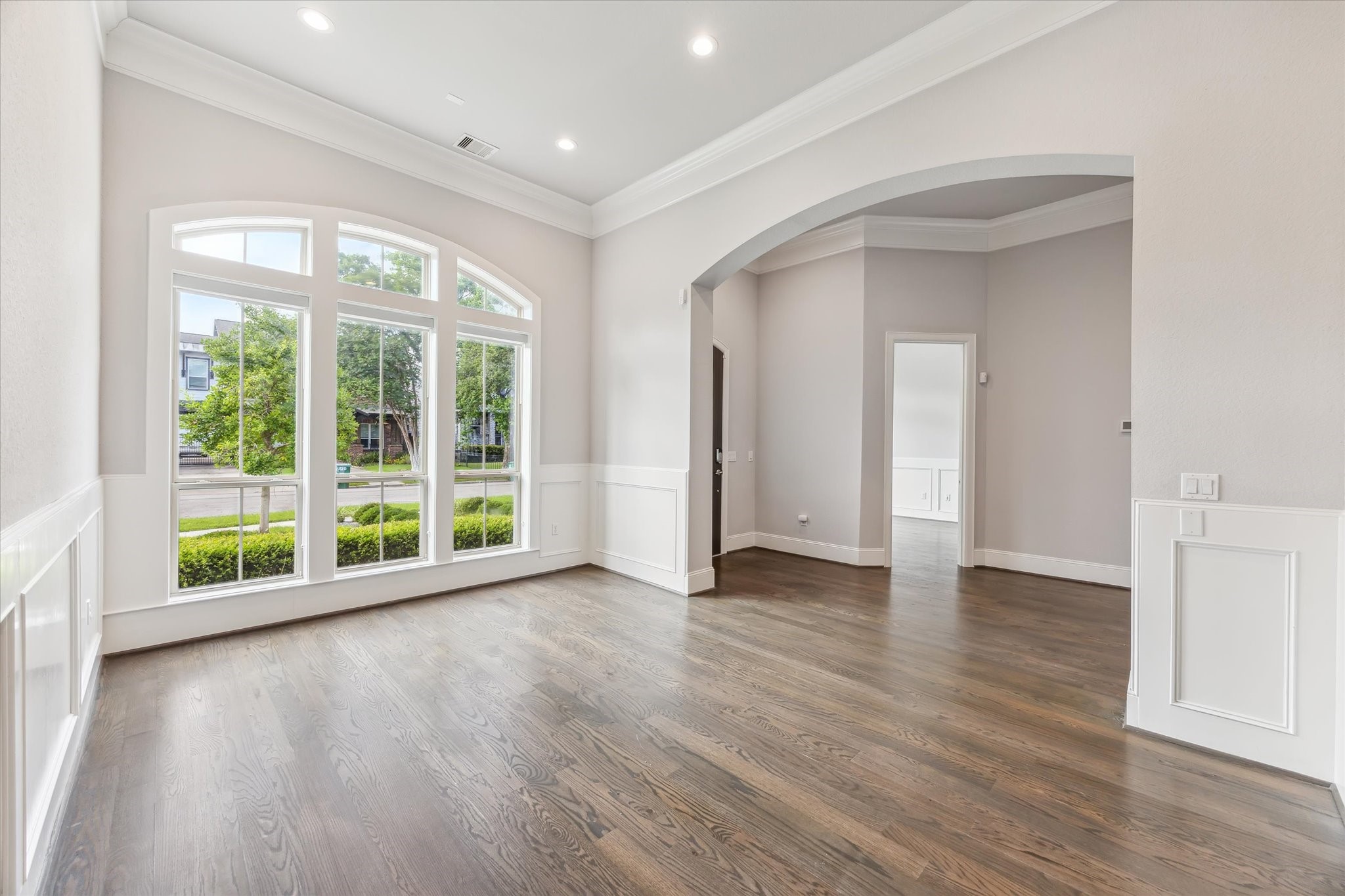 1721 Colquitt Street Houston, TX 77098 - Photo 5 of 30 a view of an empty room with wooden floor and a window