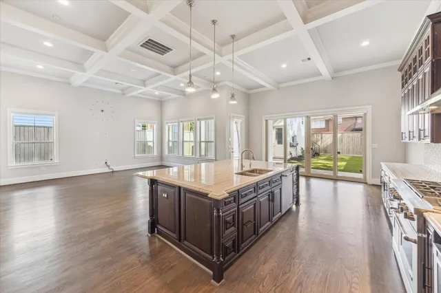 a spacious kitchen with stainless steel appliances granite countertop a lot of counter space and wooden floors