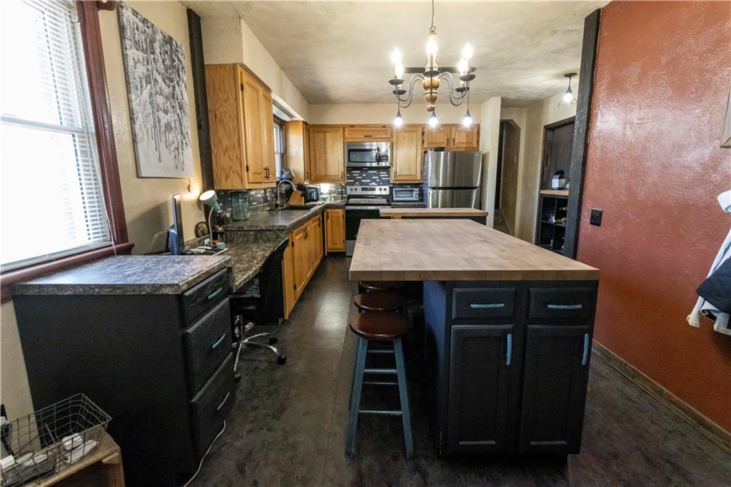 842 Anderson Street Confluence, PA 15424 - Photo 20 of 43 a large kitchen with a table chairs and stove
