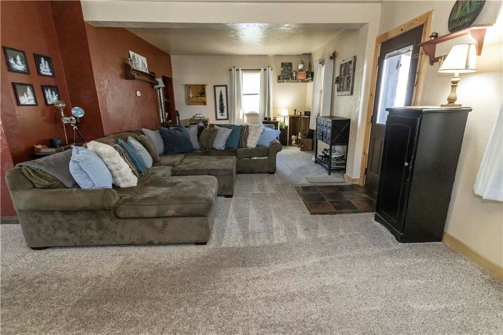 842 Anderson Street Confluence, PA 15424 - Photo 9 of 43 a living room with furniture a refrigerator and a couch