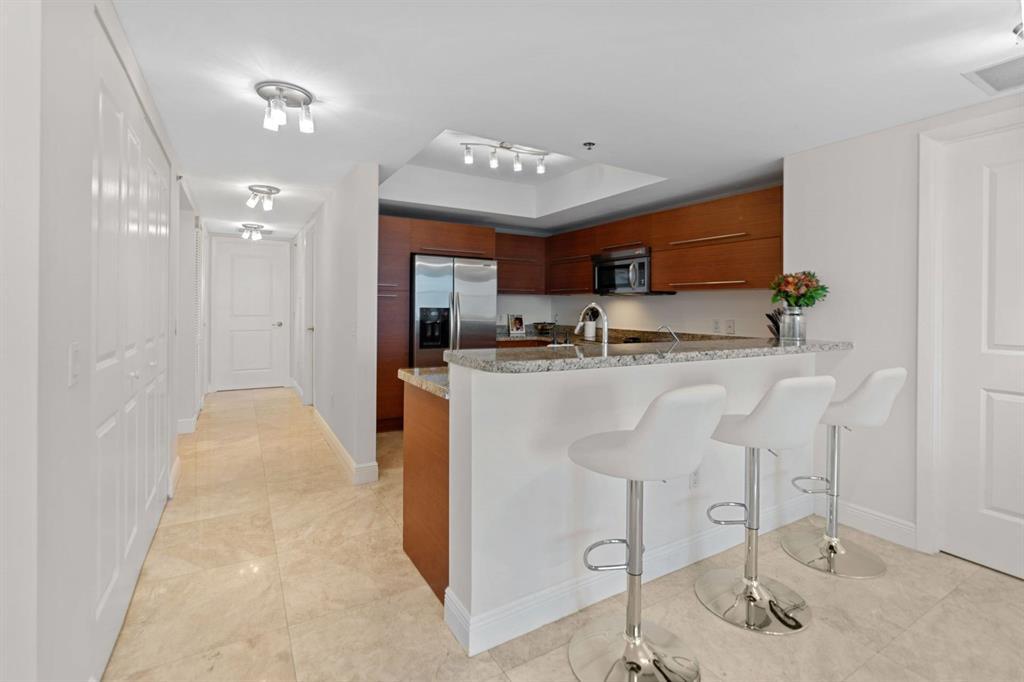 a kitchen with kitchen island a sink stainless steel appliances and cabinets