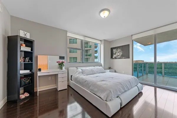 a bedroom with a large bed and a large window