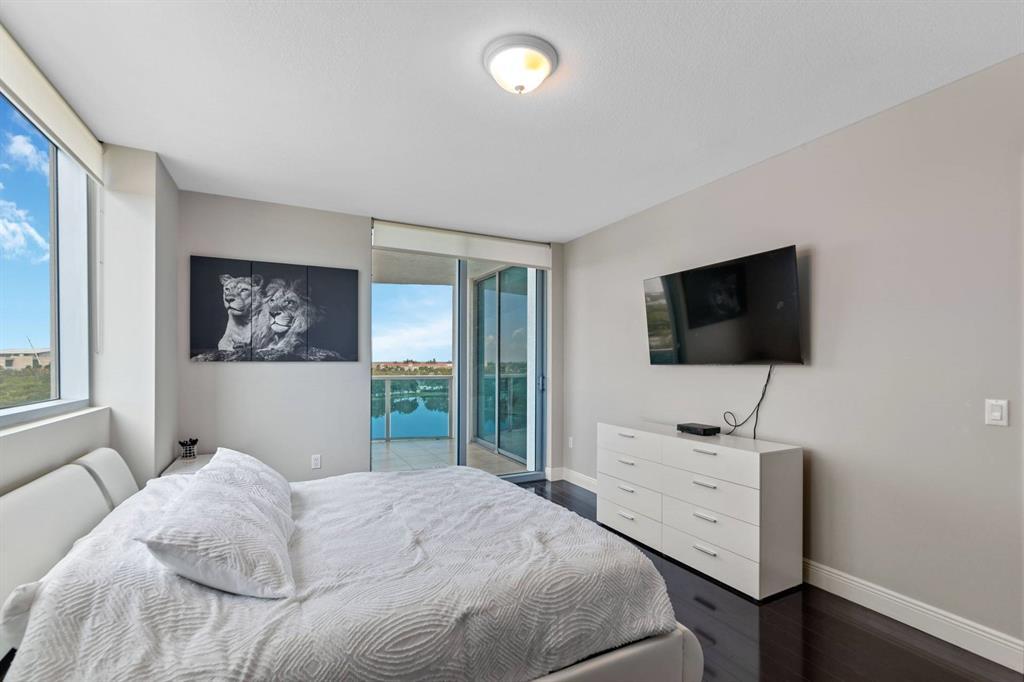 2641 North Flamingo Road Plantation, FL 33323 - Photo 17 of 23 a bedroom with a bed and a flat screen tv