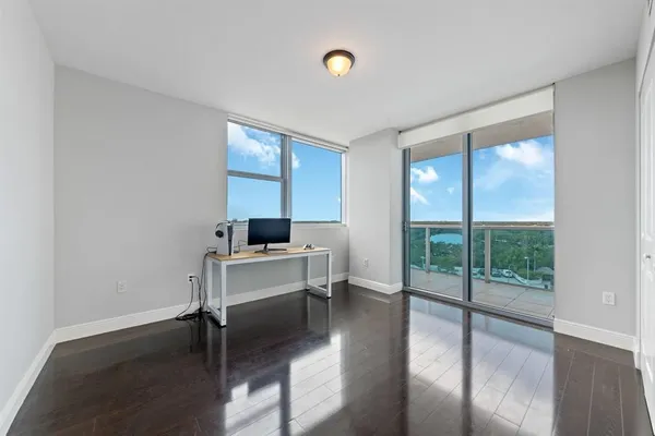 a view of a workspace with furniture and a window