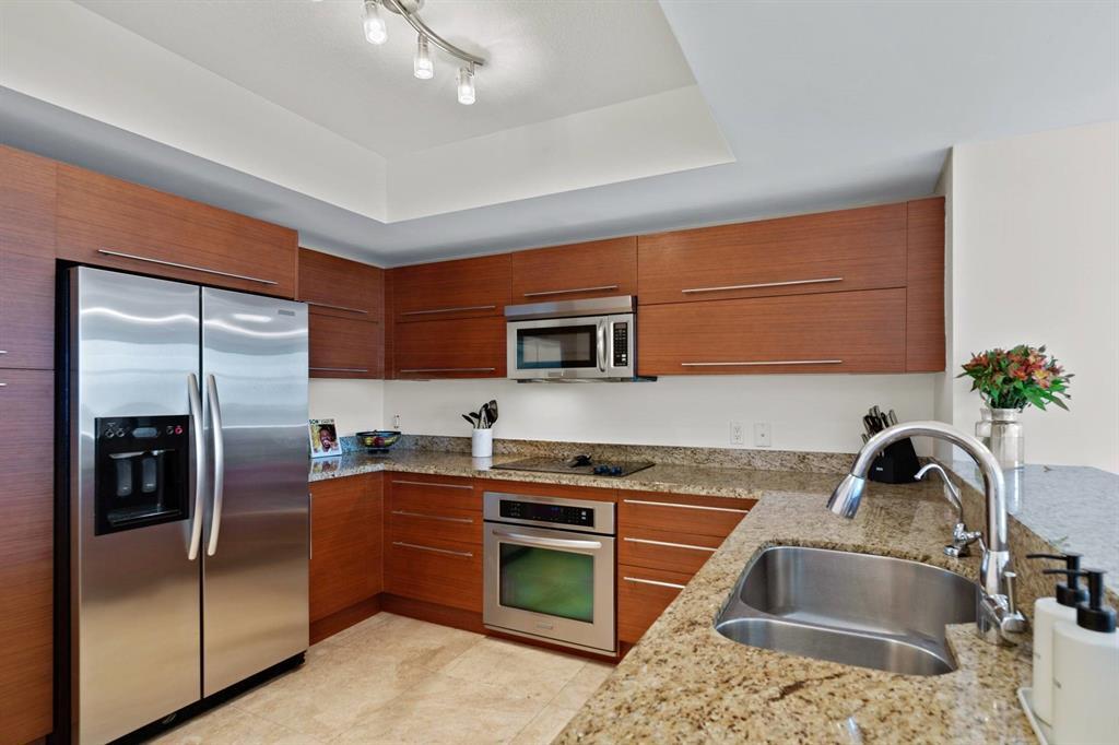 2641 North Flamingo Road Plantation, FL 33323 - Photo 8 of 23 a kitchen with stainless steel appliances granite countertop a sink stove and refrigerator