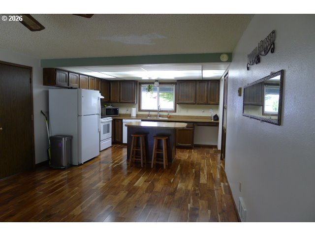 412 Camellia Court Reedsport, OR 97467 - Photo 21 of 48 a kitchen with stainless steel appliances granite countertop a refrigerator and a stove top oven