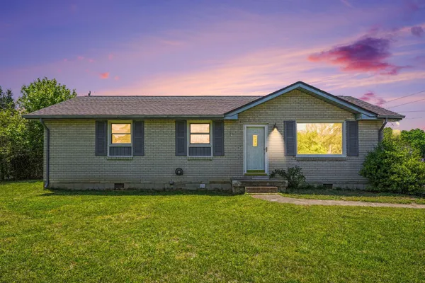 a front view of a house with a yard