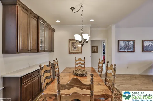 a living room with couches a dining table and kitchen view with wooden floor