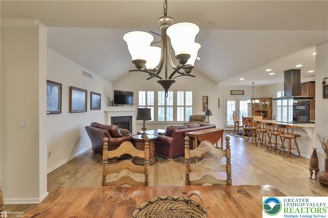 4109 Eveningstar Road Emmaus, PA 18049 - Photo 20 of 57 a living room with couches a dining table and kitchen view with wooden floor